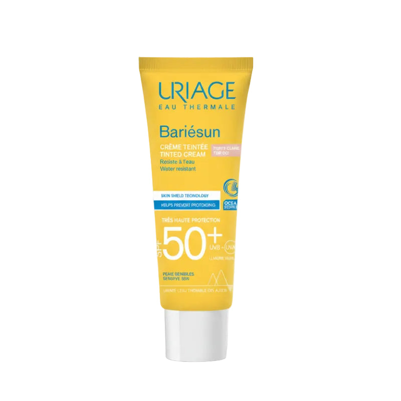 Uriage Bariésun sunscreen cream tube with a hand applying it on a white background