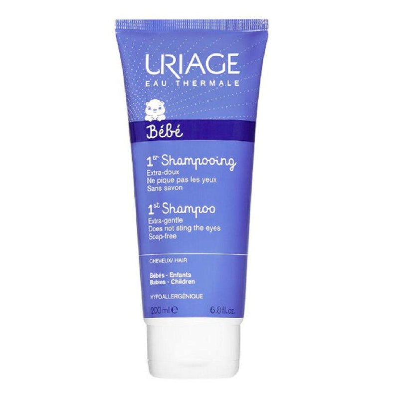 A tube of Uriage Bebe First Shampoo, primarily blue in color with white and purple accents, designed for infants.