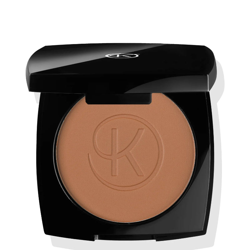 Compact powder in a black case with a brand logo on a white background