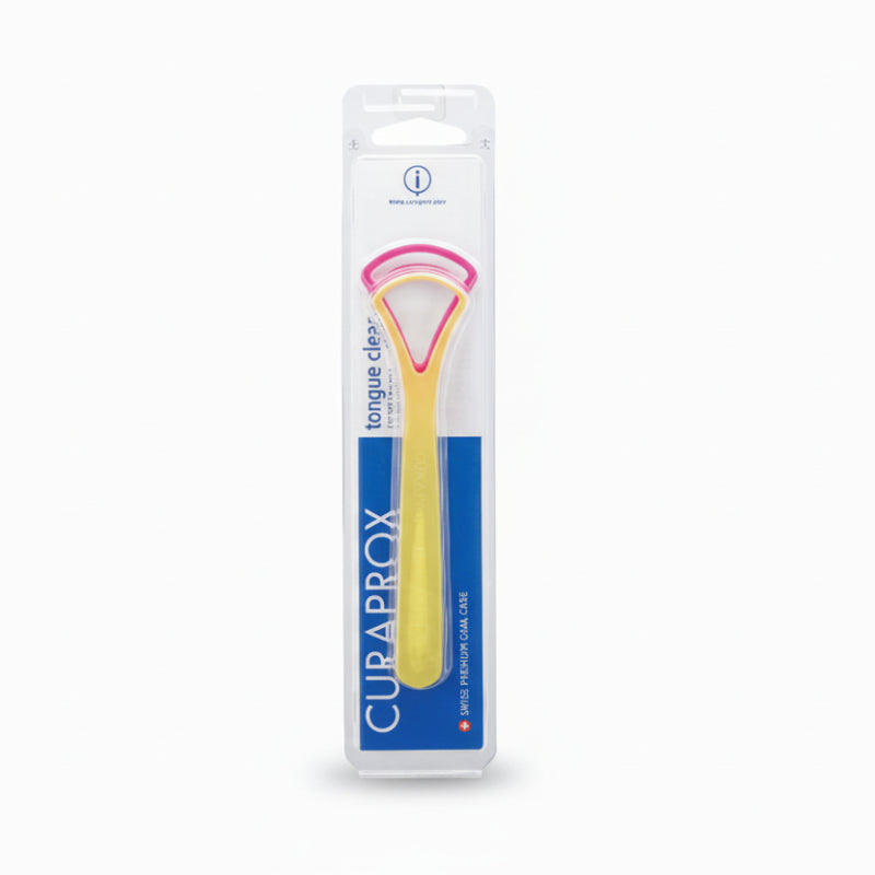 A CURAPROX brand tongue cleaner in packaging, with a yellow and pink tongue cleaner visible through a clear plastic window.